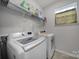 Bright laundry room with shelving and modern washer and dryer at 18022 Stark Way, Charlotte, NC 28278