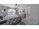 The main bedroom has a bathroom, a dresser, and a patterned bedspread at 18022 Stark Way, Charlotte, NC 28278