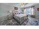 Bright main bedroom featuring mirrored nightstands and a patterned bedspread at 18022 Stark Way, Charlotte, NC 28278