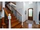 Elegant wooden staircase with wrought iron railing in a bright entryway at 234 Glenbrook Springs None, New London, NC 28127