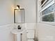 Clean bathroom with pedestal sink and tiled walls at 3227 Starrland Dr, Gastonia, NC 28052