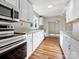 Modern kitchen with white cabinets, stainless steel appliances, and wood flooring at 350 Orr Dr, Rock Hill, SC 29730