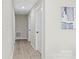 Clean hallway with light walls and wood-look flooring at 3722 Unionville Indian Trail W Rd, Indian Trail, NC 28079