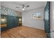 Spacious bedroom with dark green accent wall and wood floors at 3732 Mckelvey St, Charlotte, NC 28215