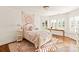 Charming bedroom with bay window, hardwood floors, and a lovely pink bedding set at 424 Fairhaven Ct, Waxhaw, NC 28173