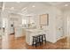 Modern kitchen with white cabinetry, breakfast bar, and hardwood floors at 424 Fairhaven Ct, Waxhaw, NC 28173