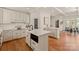 Spacious kitchen featuring a large island, white cabinetry, and hardwood floors at 424 Fairhaven Ct, Waxhaw, NC 28173