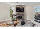 Comfortable living area featuring a stone fireplace and a view of the lake at 424 Fairhaven Ct, Waxhaw, NC 28173