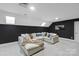 Relaxing recreation room with a large sectional sofa and dark accent wall at 424 Fairhaven Ct, Waxhaw, NC 28173
