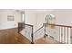 Grand staircase with wrought iron railings and hardwood floors at 424 Fairhaven Ct, Waxhaw, NC 28173