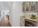 Convenient wet bar with glass-front cabinets and a wine refrigerator at 424 Fairhaven Ct, Waxhaw, NC 28173