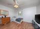 Bright bedroom with wood floors, a double bed, and a dresser at 5260 Nc Hwy 73 Hwy, Iron Station, NC 28080