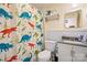 Bathroom with dinosaur shower curtain, white vanity, and a toilet at 625 N 3Rd St, Albemarle, NC 28001