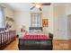 Bedroom featuring a sleigh bed, crib, and ceiling fan at 625 N 3Rd St, Albemarle, NC 28001