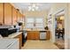 Well-equipped kitchen with wood cabinets, microwave, and dishwasher at 625 N 3Rd St, Albemarle, NC 28001