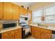 View of kitchen stove, countertops, and cabinets at 625 N 3Rd St, Albemarle, NC 28001
