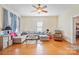 Living room boasts hardwood floors, a comfy sectional, and a ceiling fan at 625 N 3Rd St, Albemarle, NC 28001