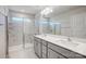 Bathroom with double vanity, glass shower, and marble tile at 6337 Mallow Crossing Ln, Charlotte, NC 28213