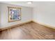 Spacious bedroom with light wood floors and a large window at 638 Chipley Ave # 6, Charlotte, NC 28205