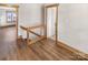 Upstairs hallway with wood flooring and access to bedrooms and bath at 638 Chipley Ave # 6, Charlotte, NC 28205