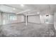 Finished basement with gray carpeting, recessed lighting, and multiple access points at 6514 Highwood Pl, Charlotte, NC 28210