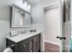 Updated bathroom with vanity, new flooring, and a shower at 6514 Highwood Pl, Charlotte, NC 28210