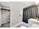 Basement bathroom with shower/tub combo, white vanity, and closet at 6514 Highwood Pl, Charlotte, NC 28210