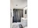 Basement bathroom with shower/tub combo, white vanity, and gray patterned floor at 6514 Highwood Pl, Charlotte, NC 28210