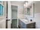 Clean bathroom with vanity, updated tile, and a mirror at 6514 Highwood Pl, Charlotte, NC 28210