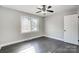 Spacious bedroom with dark hardwood floors and ceiling fan at 6514 Highwood Pl, Charlotte, NC 28210