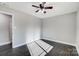 Bright bedroom with dark hardwood floors and ceiling fan at 6514 Highwood Pl, Charlotte, NC 28210