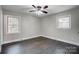 Bright bedroom with hardwood floors and two windows at 6514 Highwood Pl, Charlotte, NC 28210