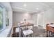 Small dining area with wooden table and four cushioned stools at 6514 Highwood Pl, Charlotte, NC 28210