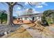 Brick ranch home with walkway, deck, and mature tree at 6514 Highwood Pl, Charlotte, NC 28210