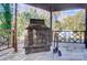 Stone fireplace with metal screen in backyard gazebo at 6514 Highwood Pl, Charlotte, NC 28210