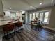 Eat-in kitchen with bar seating and a dining area bathed in natural light at 6514 Highwood Pl, Charlotte, NC 28210