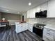 Bright kitchen with white cabinets, marble backsplash, and stainless steel appliances at 6514 Highwood Pl, Charlotte, NC 28210