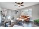 Sunlit living area, featuring a brown sofa and armchairs at 6514 Highwood Pl, Charlotte, NC 28210