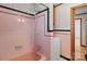 Pink tiled bathroom with tub and shower at 700 Snuggs St, Albemarle, NC 28001