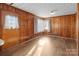 Room with wood paneling, and laminate flooring at 700 Snuggs St, Albemarle, NC 28001