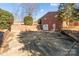 Detached brick garage with a large driveway at 700 Snuggs St, Albemarle, NC 28001