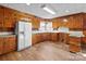 Spacious kitchen with wood cabinets and flooring at 700 Snuggs St, Albemarle, NC 28001
