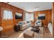 Virtually staged living room with wood walls at 700 Snuggs St, Albemarle, NC 28001