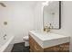 Modern bathroom with a white quartz vanity and gold fixtures at 741 Mcalway Rd, Charlotte, NC 28211