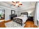 Bright bedroom with hardwood floors, a ceiling fan, and a queen-size bed at 814 Water Wheel Ct, Charlotte, NC 28209