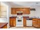 View of kitchen with wood cabinets and a white stove at 9336 Amy Dr, Charlotte, NC 28213