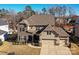 Stunning two-story home with stone and siding exterior, two-car garage, and manicured landscaping at 936 Gabriel Jon Pl, Fort Mill, SC 29707