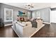 Living room with a stone fireplace, hardwood floors, and a sectional sofa at 936 Gabriel Jon Pl, Fort Mill, SC 29707