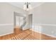 Dining room with hardwood floors, chandelier, and view of staircase at 10811 Wyndham Pointe Dr, Charlotte, NC 28213