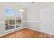 Bright dining room with hardwood floors and view of backyard at 10811 Wyndham Pointe Dr, Charlotte, NC 28213